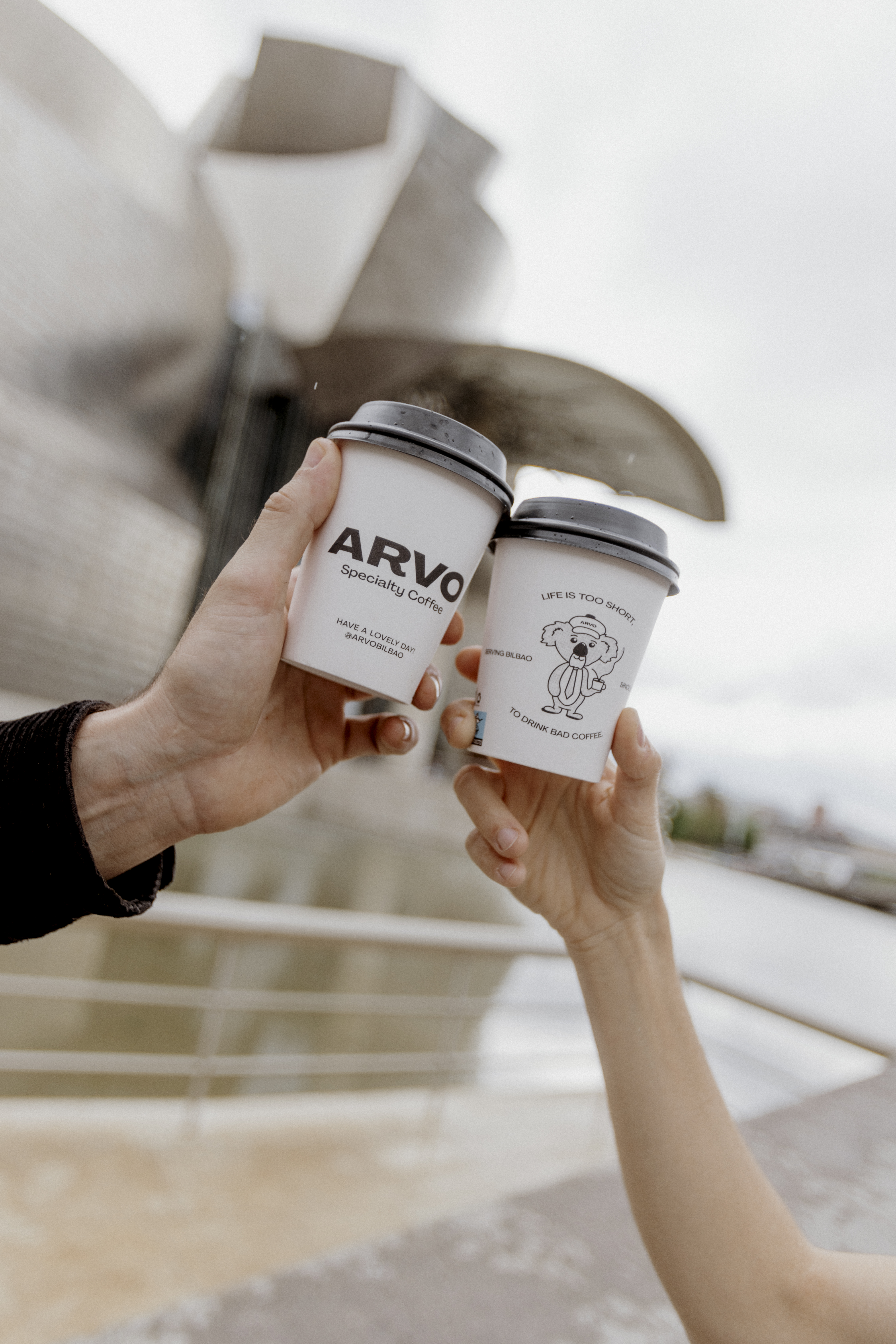 ARVO Specialty Coffee cups in front of the Guggenheim Museum Bilbao